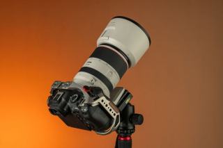 The telephoto lens sits at the centre of almost every privacy case Long lens raised above a crowd behind a barrier at night